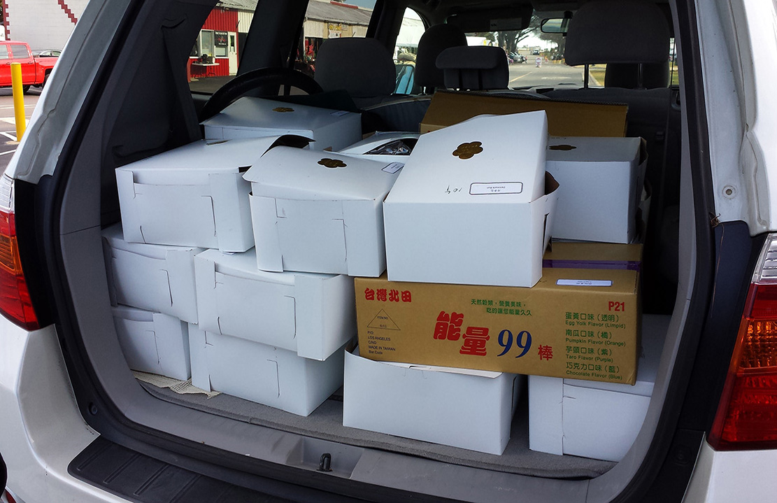Boxes of breads and buns from Grand Asia Market, ready to be transported to the festival!